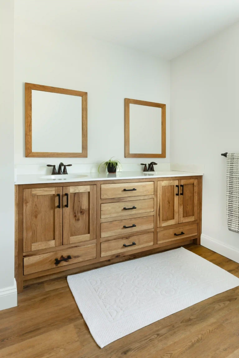 Custom wooden bathroom vanity with double sinks and black hardware.